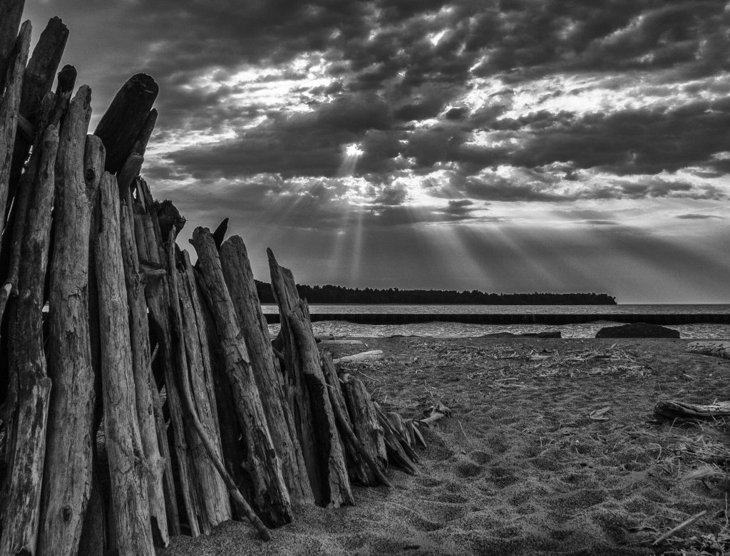 Black-and-white landscape photo of pilings by the Lake Superior shore near the Apostle Islands National Lakeshore, Wisconsin, black and white