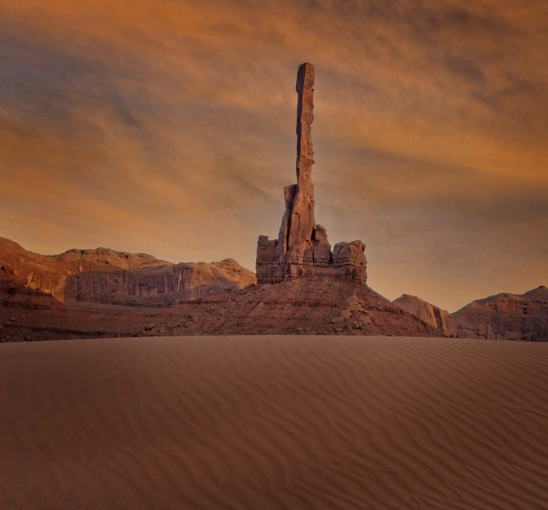 Landscape photo of the "Totem Pole" formation in Monument Valley Navajo Tribal Park, Arizona